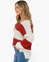 Beach Rose Co. red and cream wide stripe V-neck sweater with dropped shoulders worn by a woman in jeans