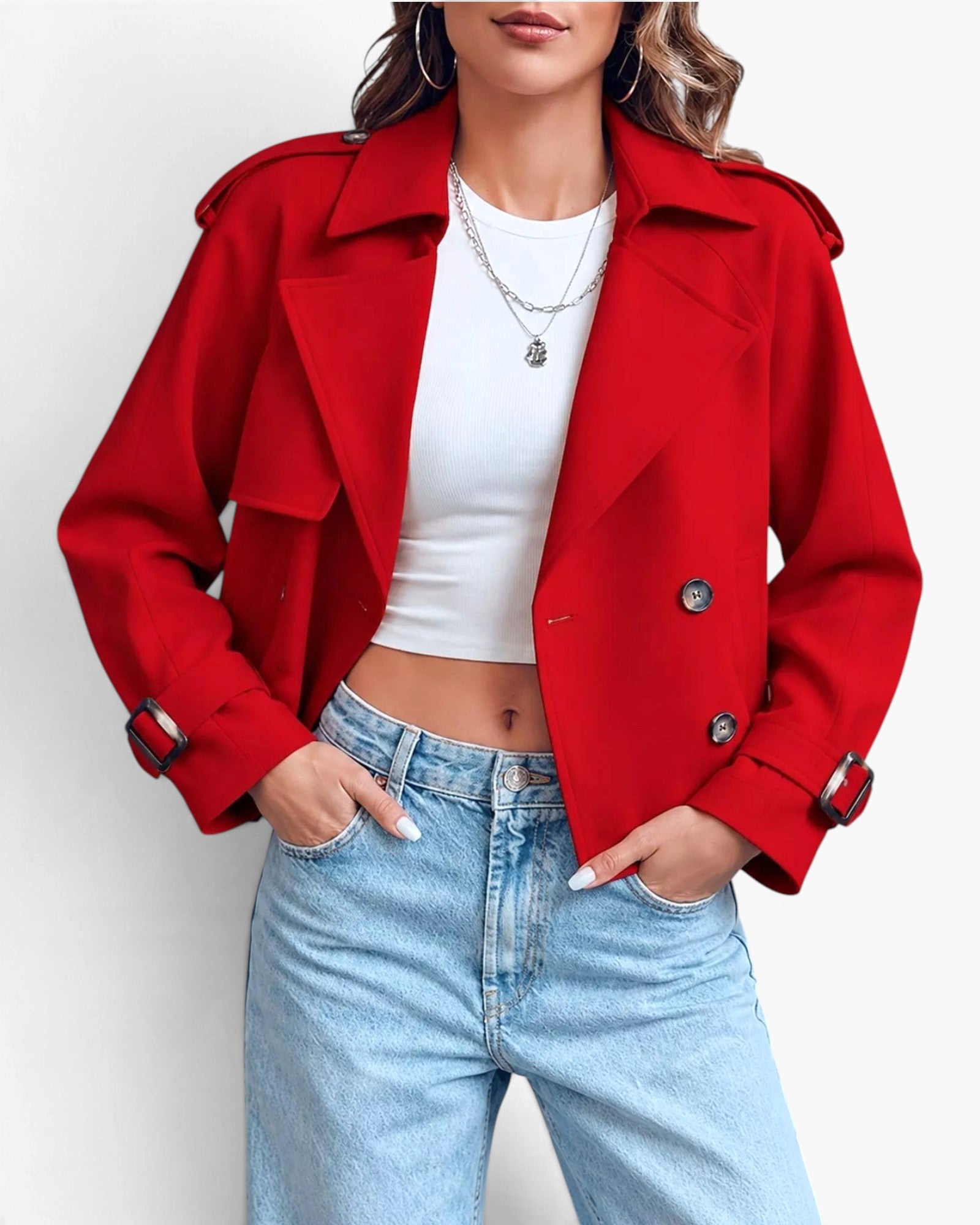 Beach Rose Co. red cropped double-breasted trench jacket with wide lapels and buckled cuffs worn with light blue jeans