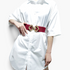 Beach Rose Co. red elastic waist belt with a gold-toned geometric diamond buckle worn over a white shirt dress