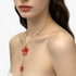 Beach Rose Co. Y-shaped gold-plated necklace featuring red resin flowers and white faux pearl accents on a delicate chain