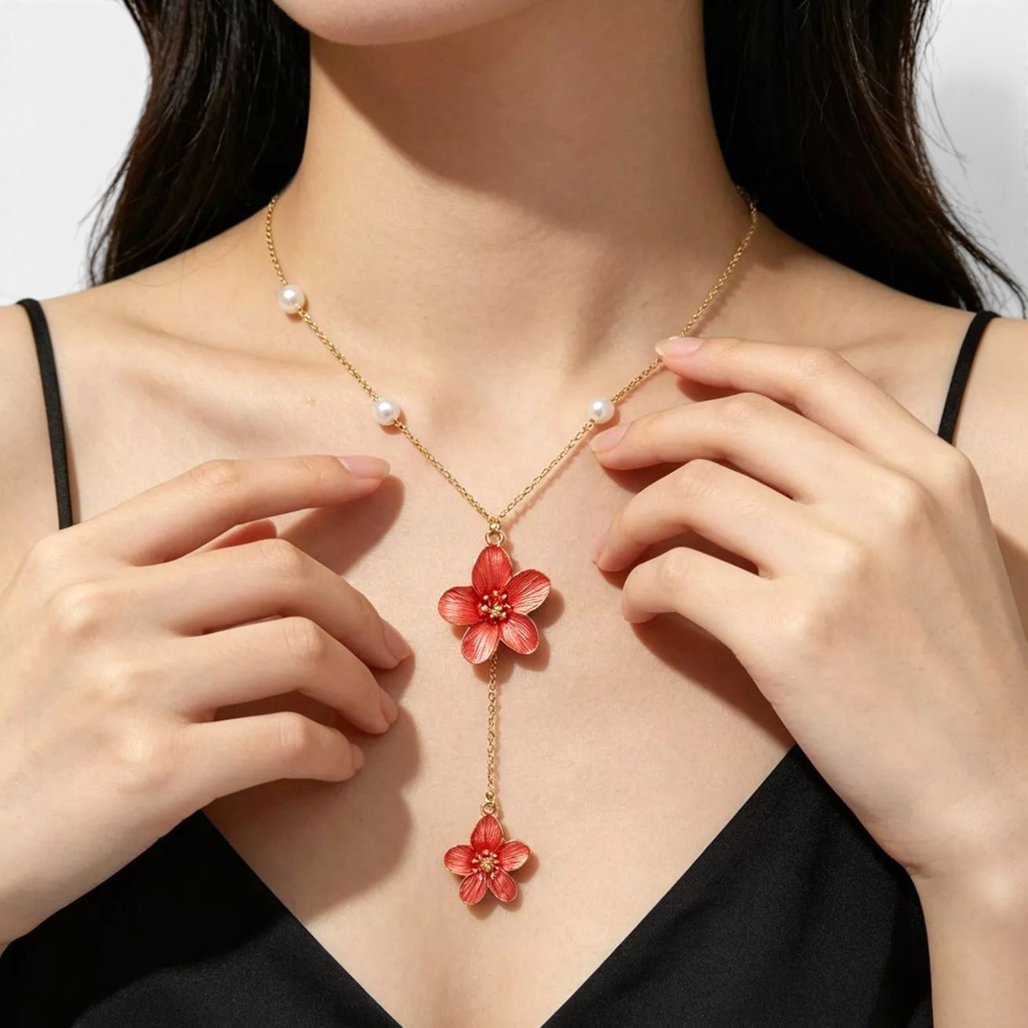 Beach Rose Co. 18K gold-plated Y-necklace featuring two red resin flowers and white faux pearl accents on a fine chain.