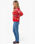Beach Rose Co. red knit holiday sweater with gingerbread and Christmas tree patterns worn by a blonde model