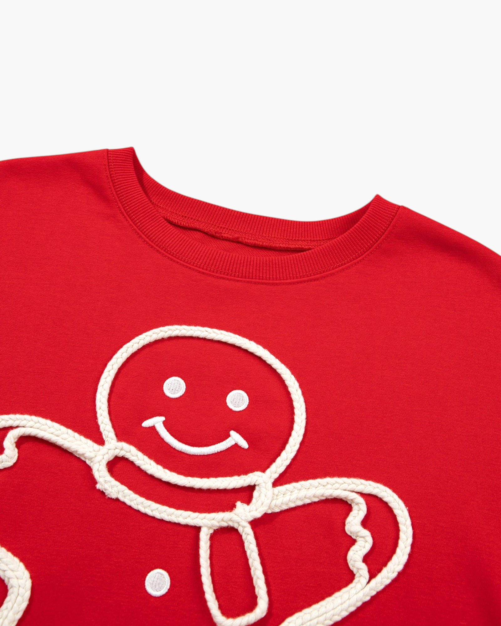 Beach Rose Co. red sweatshirt featuring a smiling gingerbread man with textured cream rope trim and button details.