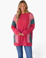 Beach Rose Co. model wearing a red ribbed tunic with green panels and red-white gingham patchwork, long sleeves.