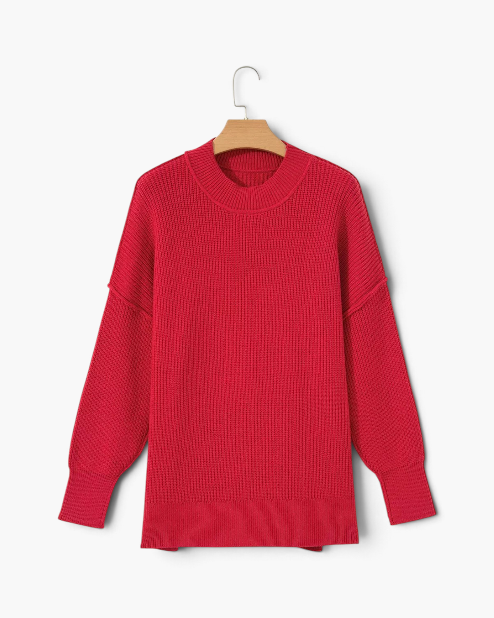 Beach Rose Co. red relaxed knit sweater with dropped shoulders, exposed seams, and wide ribbed cuffs on a hanger.