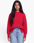 Beach Rose Co. red relaxed knit sweater with dropped shoulders and exposed seams worn by a model with jeans.
