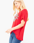Beach Rose Co. red short-sleeve graphic tee with leopard-print lips design, worn by a blonde model in profile view.