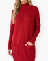 Beach Rose Co. red sweater dress with a ribbed mock neck, long sleeves, and front patch pockets on a blonde model.