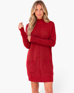 Beach Rose Co. red sweater dress with a ribbed mock neck, long sleeves, and front patch pockets on a blonde model.
