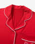 Beach Rose Co. red pajama top with white piping, notched collar, and a bow-detailed chest pocket.