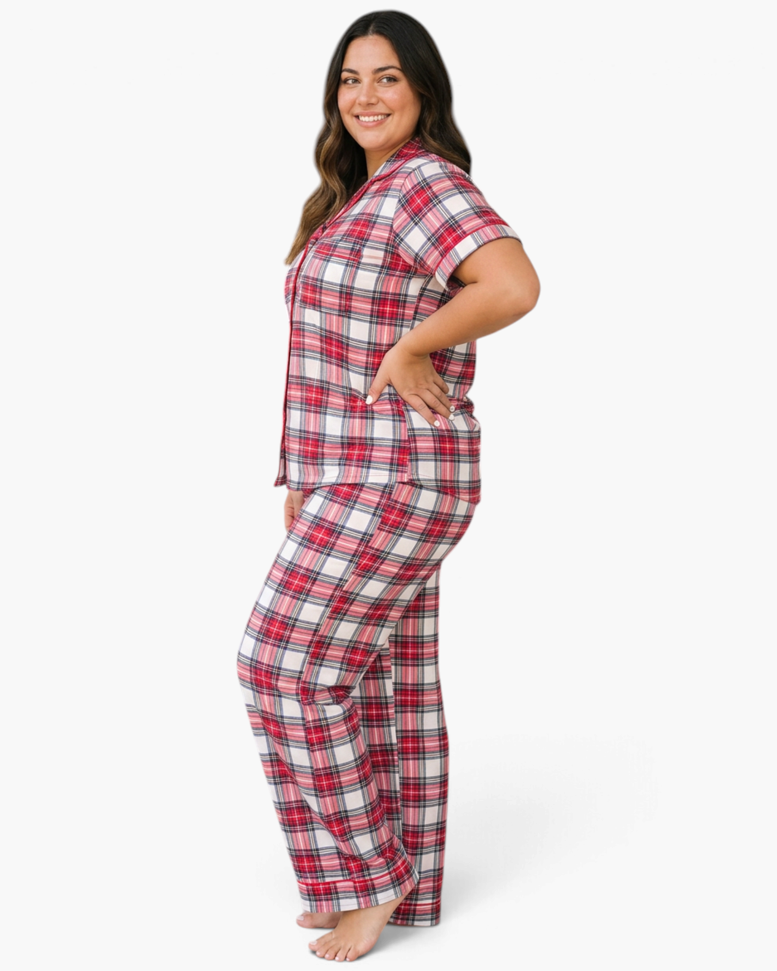 A smiling model wearing a Beach Rose Co. plus size red plaid pajama set with short sleeves and full-length pants.
