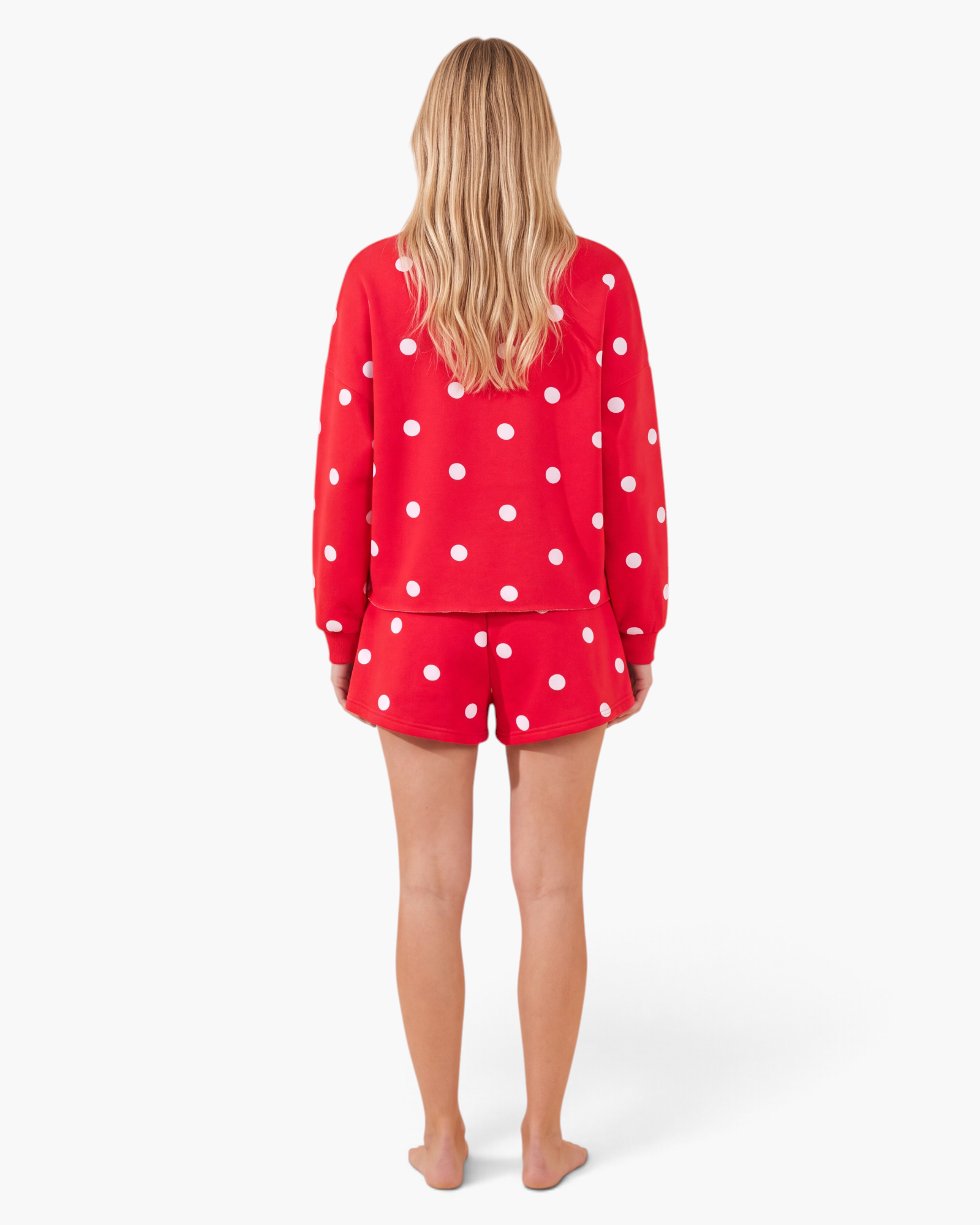 Beach Rose Co. red and white polka dot sweatshirt and skort set seen from the back on a model.
