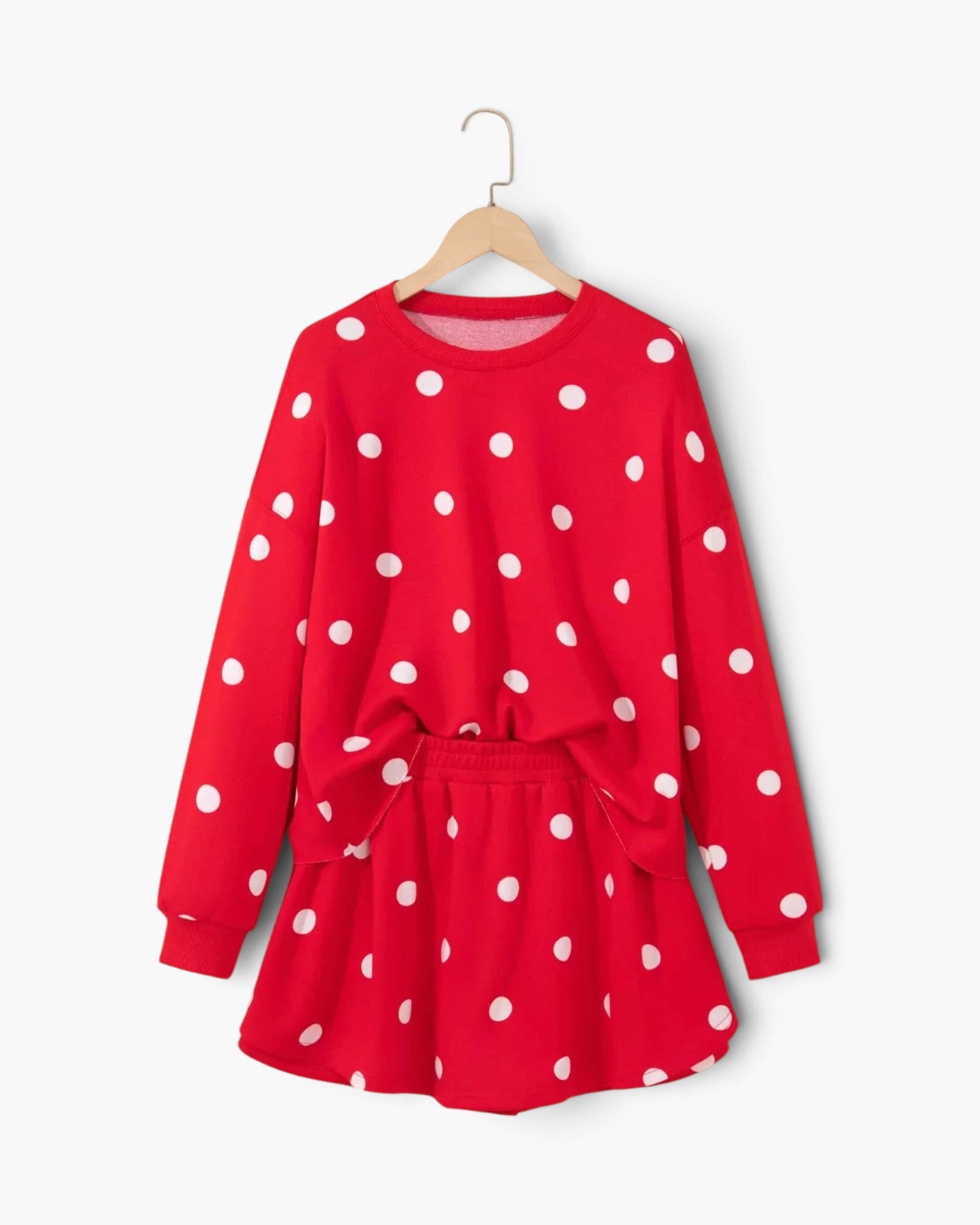 Beach Rose Co. red and white polka dot polyester sweatshirt and skort set on a hanger.