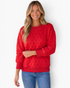 Beach Rose Co. red crewneck sweatshirt with geometric quilting, ribbed trim, and pockets worn by a smiling woman.