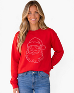 Beach Rose Co. red crewneck sweatshirt featuring a sparkling rhinestone Santa face design worn by a smiling woman.