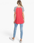 Beach Rose Co. red top with white star print and black-and-white striped raglan sleeves, back view on a model.