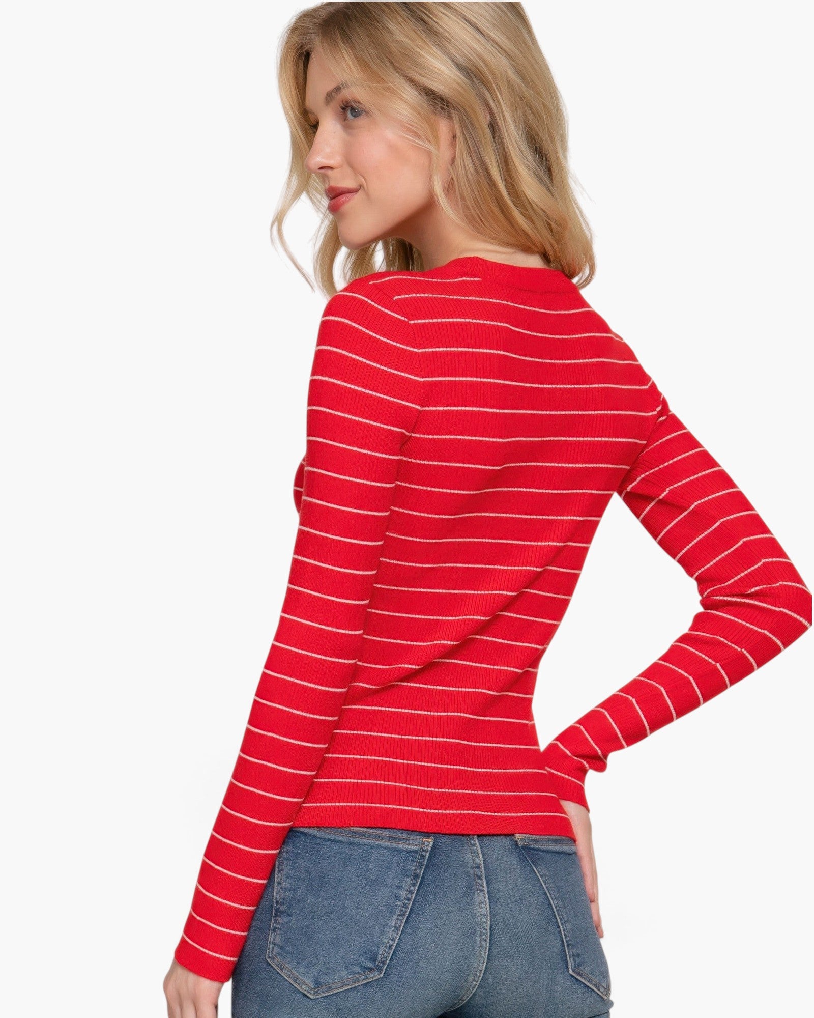 Beach Rose Co. model wearing a red and white striped long sleeve crew neck sweater with blue jeans