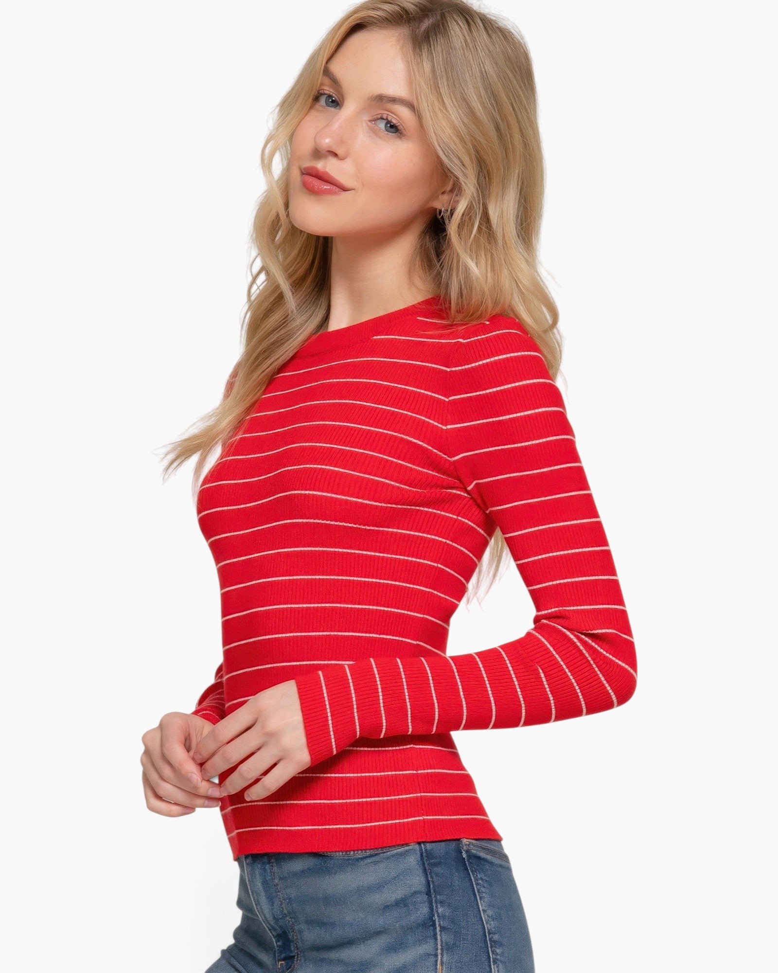 Beach Rose Co. model wearing a fitted red long sleeve sweater with thin white horizontal stripes and crew neck.