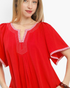 Beach Rose Co. red mini dress with notched neckline, white striped trim, and flutter sleeves in linen-cotton blend