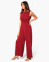 Beach Rose Co. model wearing a sleeveless deep red wide-leg jumpsuit with a flattering twist-front waist detail.