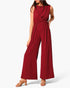 Beach Rose Co. red sleeveless jumpsuit with a twist-front waist and wide-leg silhouette on a model