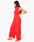 Model wearing a Beach Rose Co. red sleeveless wide-leg jumpsuit with a twist-front waist detail on a white background