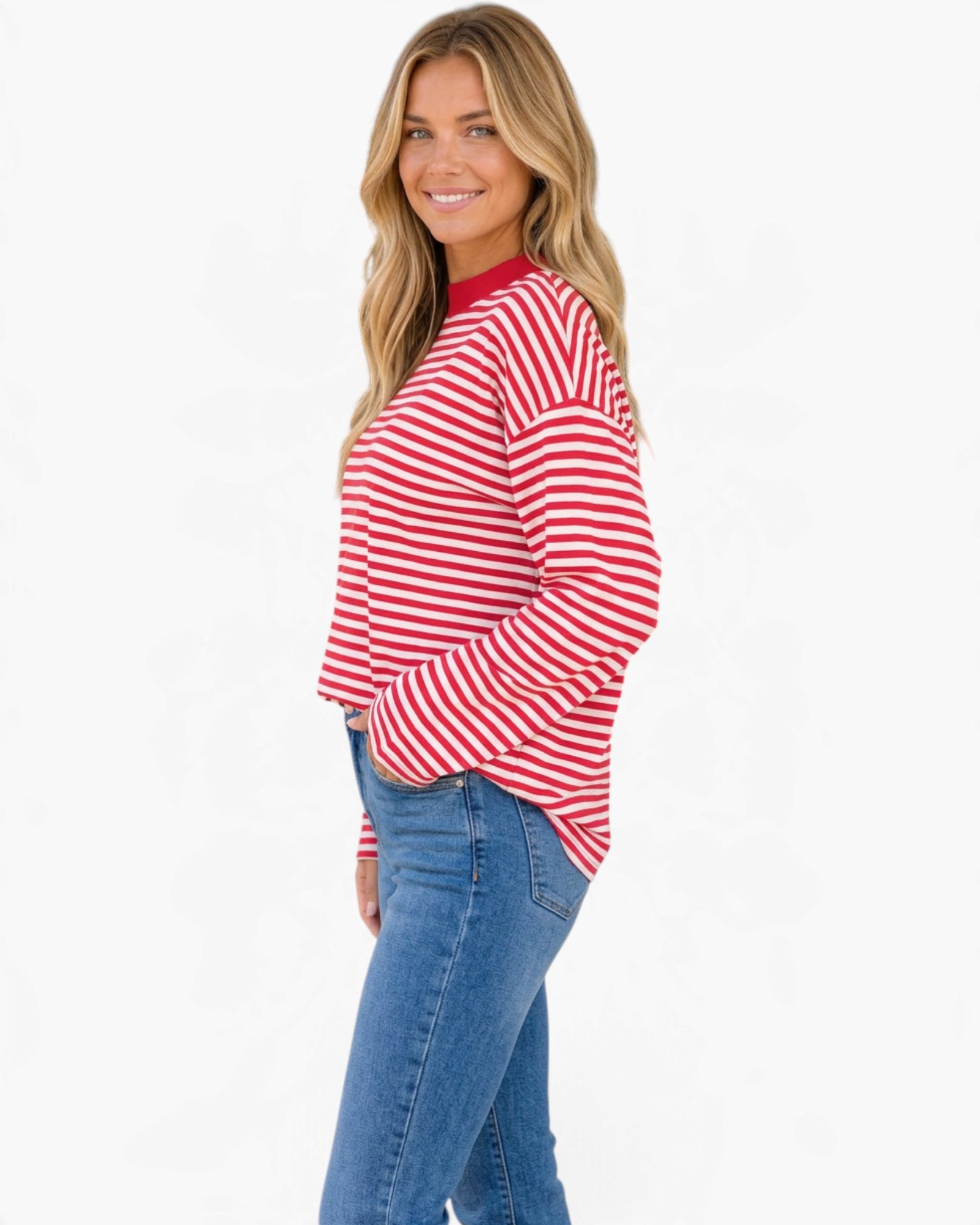 Beach Rose Co. red and white horizontal striped long sleeve top with a crewneck on a smiling model wearing jeans.