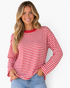 Beach Rose Co. model wearing a red and white horizontal striped long sleeve cotton top with a solid crew neckline.