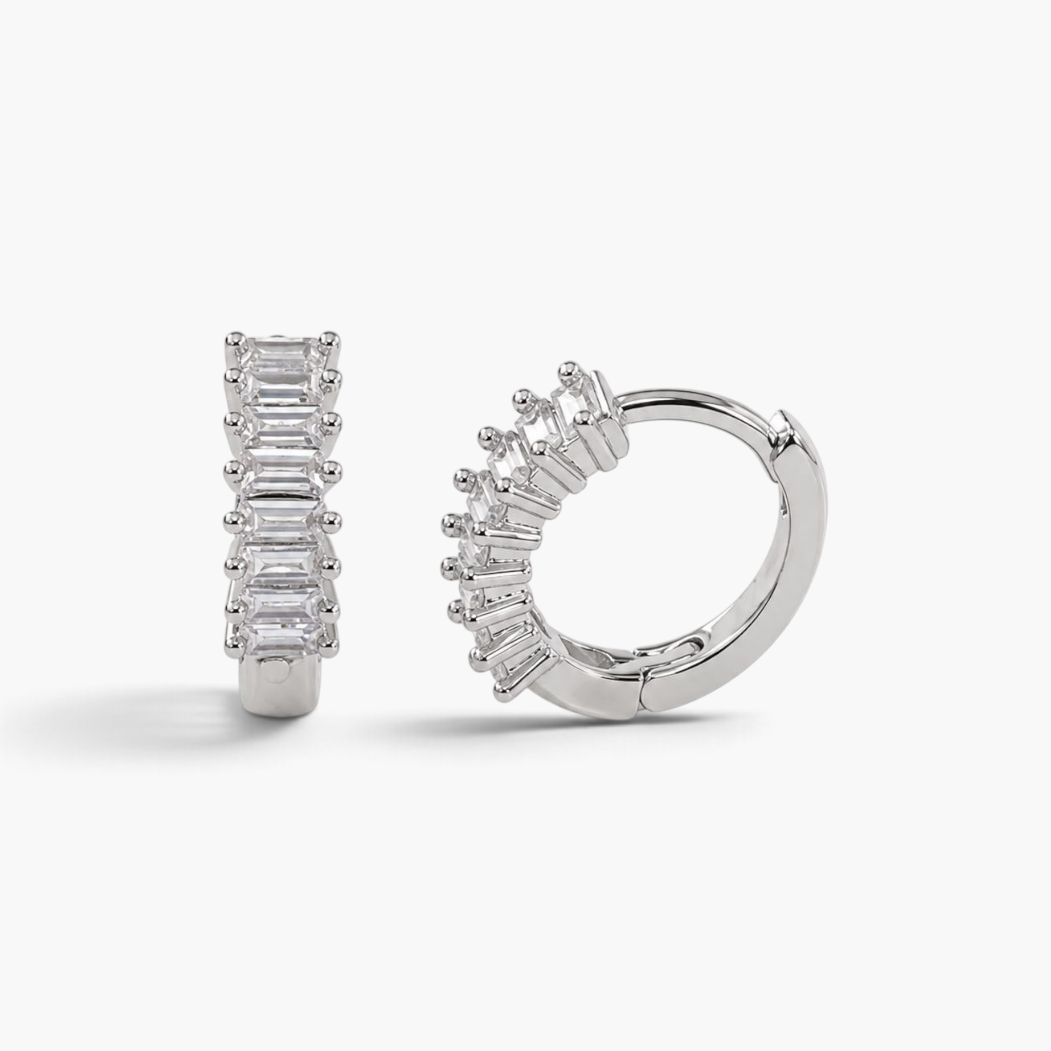 Beach Rose Co. rhodium-filled huggie hoop earrings featuring a row of sparkling baguette-cut cubic zirconia stones.