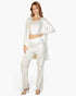 Beach Rose Co. off-white three-piece ribbed cami top, straight-leg pants, and long cardigan loungewear set on a model.