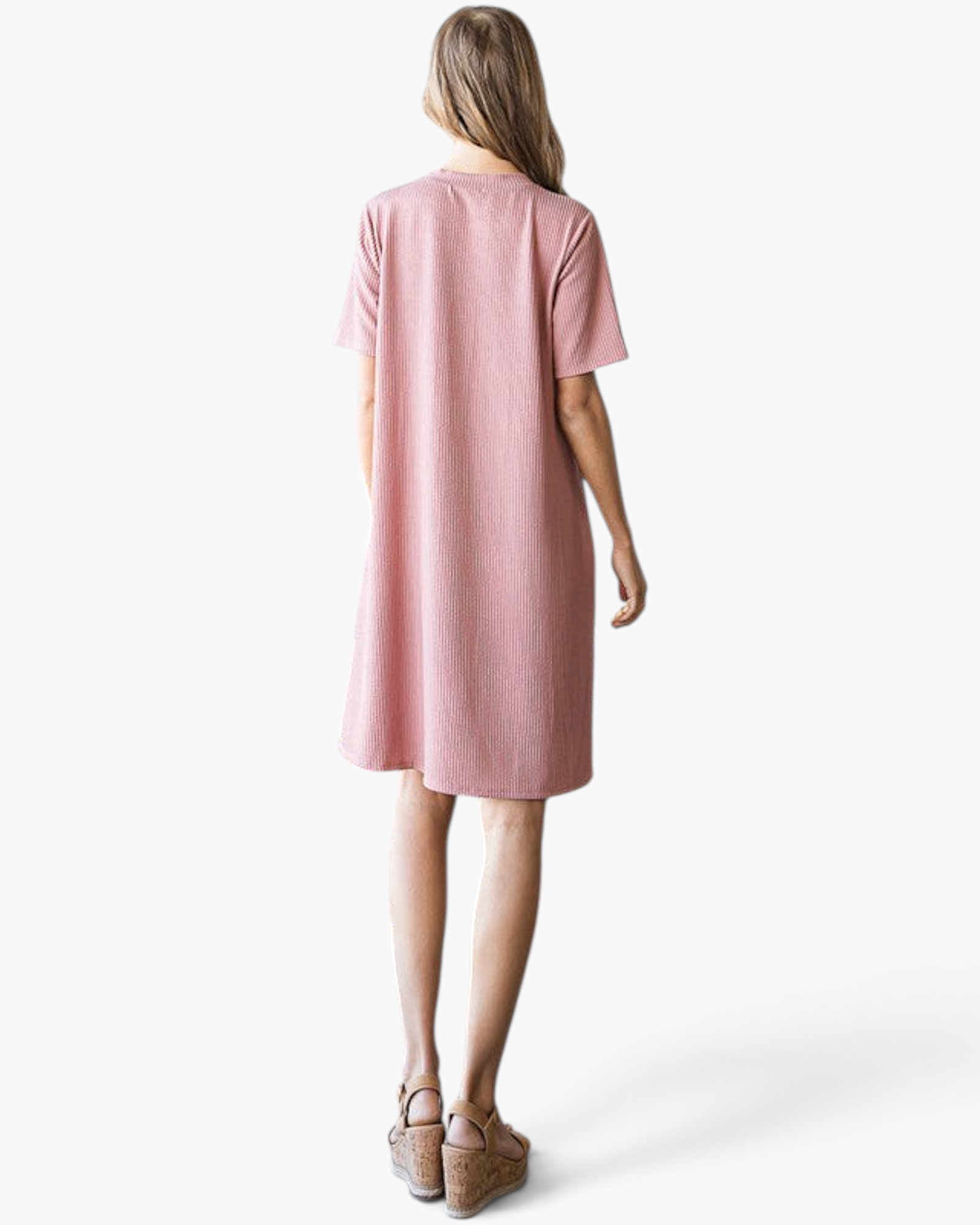 Back view of a woman wearing a Beach Rose Co. rose pink ribbed A-line t-shirt dress with short sleeves.