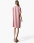 Back view of a woman wearing a Beach Rose Co. rose pink ribbed A-line t-shirt dress with short sleeves.