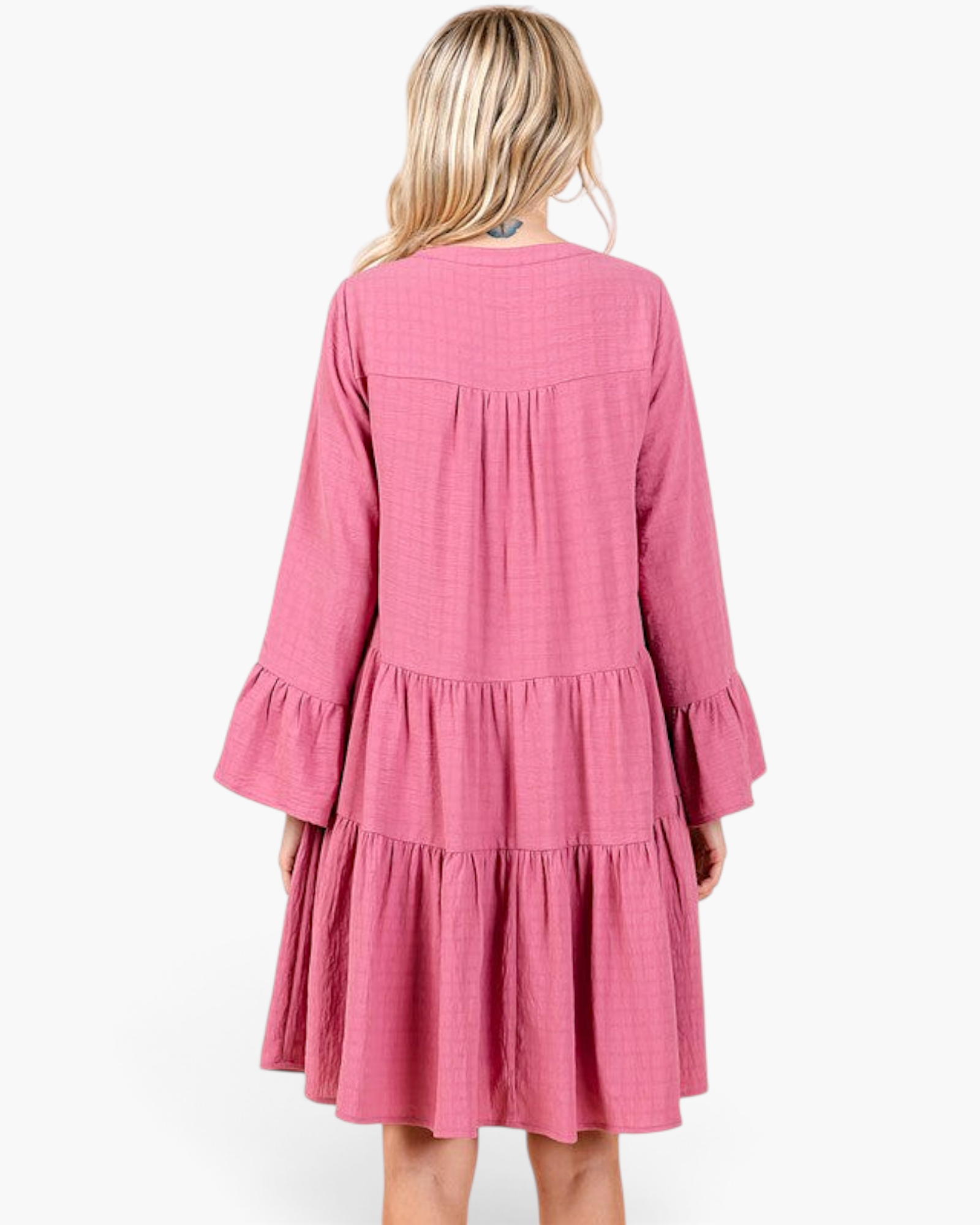 Back view of a Beach Rose Co. rose pink tiered shift dress with long bell sleeves and gathered detailing.