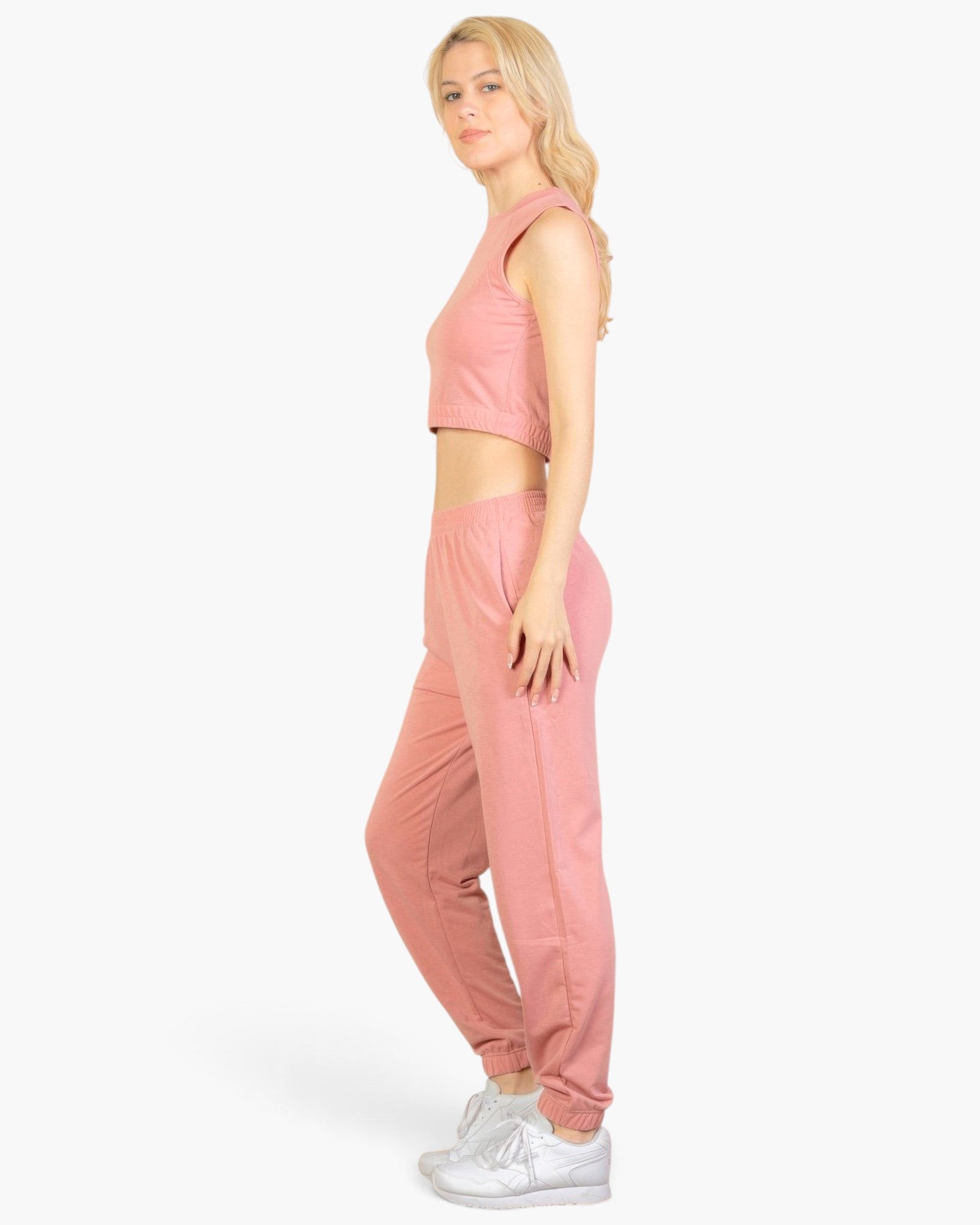Beach Rose Co. rosewood French terry tank top and joggers set worn by a blonde woman in a side profile view.