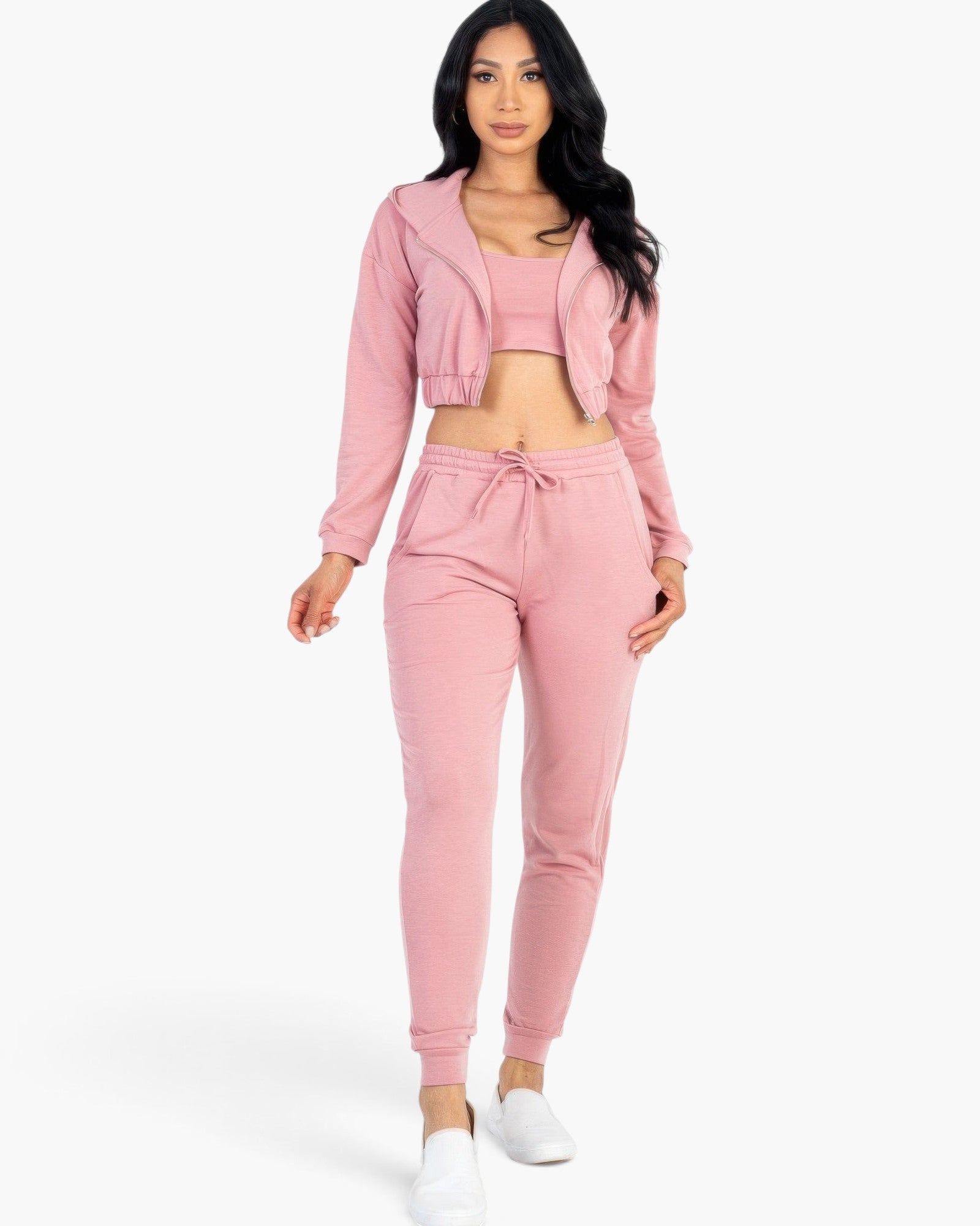 Beach Rose Co. rosewood pink French terry three-piece set with cropped cami, zip-up jacket, and joggers on a model.