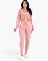 Beach Rose Co. rosewood pink French terry three-piece set with cropped cami, zip-up jacket, and joggers on a model.