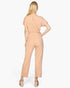 Beach Rose Co. rosewood tie waist relaxed jumpsuit in soft rib knit fabric, back view on a blonde model