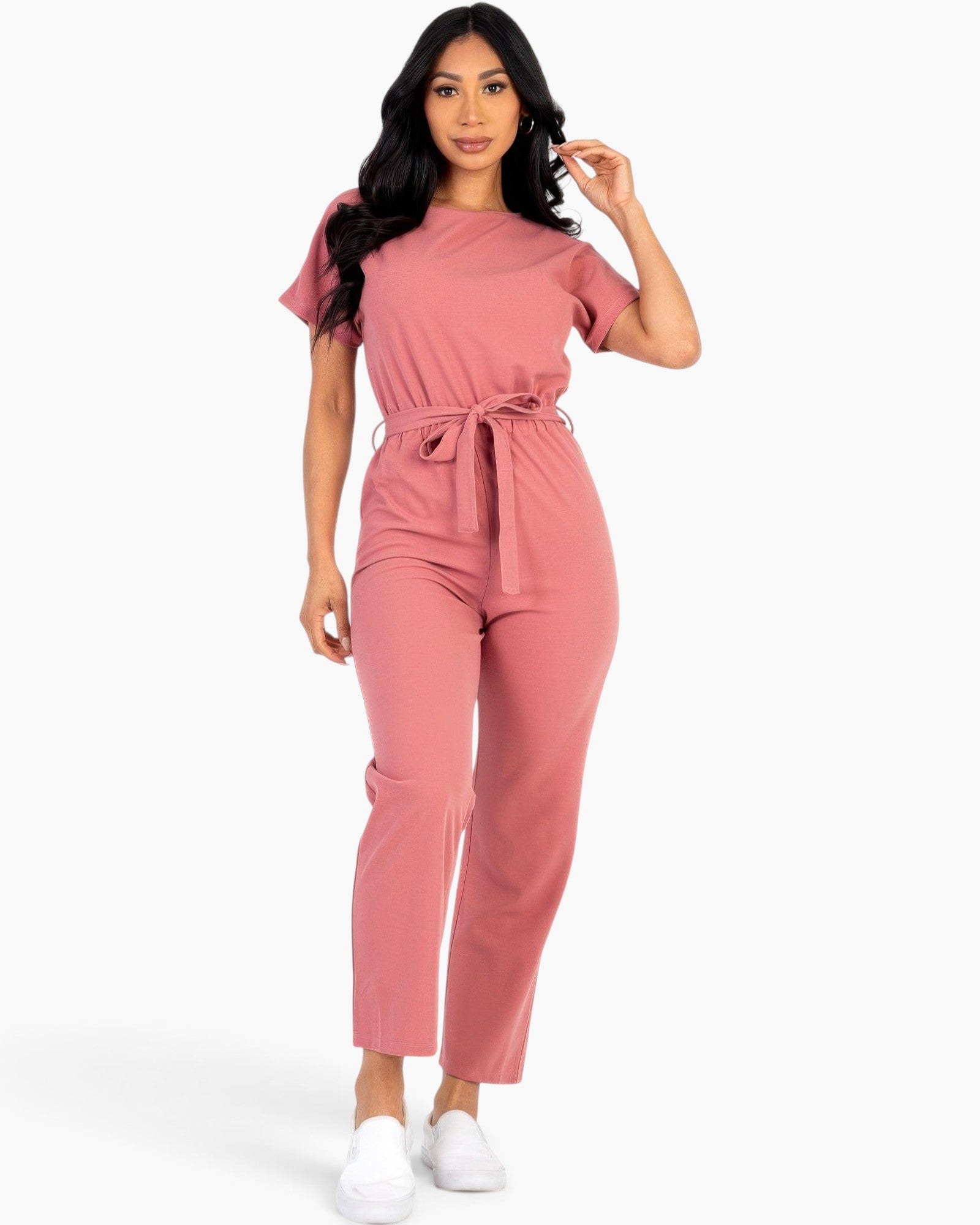 Model wearing a Beach Rose Co. rosewood pink relaxed rib knit jumpsuit with a tie waist and short sleeves.