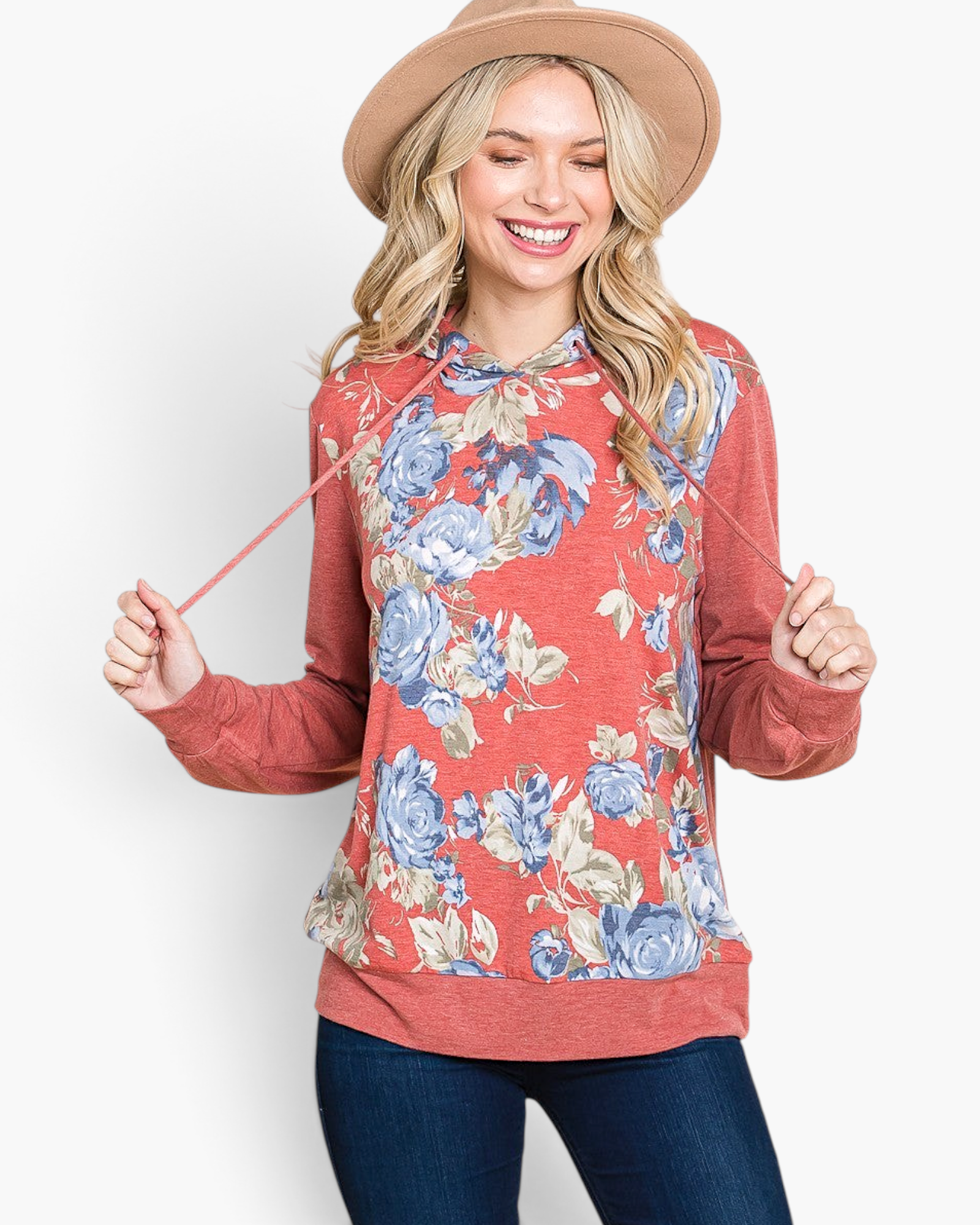 Beach Rose Co. rust floral print hoodie with relaxed fit and cuff detail worn by a smiling blonde woman in a hat