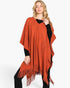 Beach Rose Co. rust orange acrylic poncho with paisley pattern and fringe hem worn by a blonde model