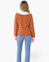Beach Rose Co. rust cardigan with white knit motifs and a scalloped collar, shown from the back on a model.