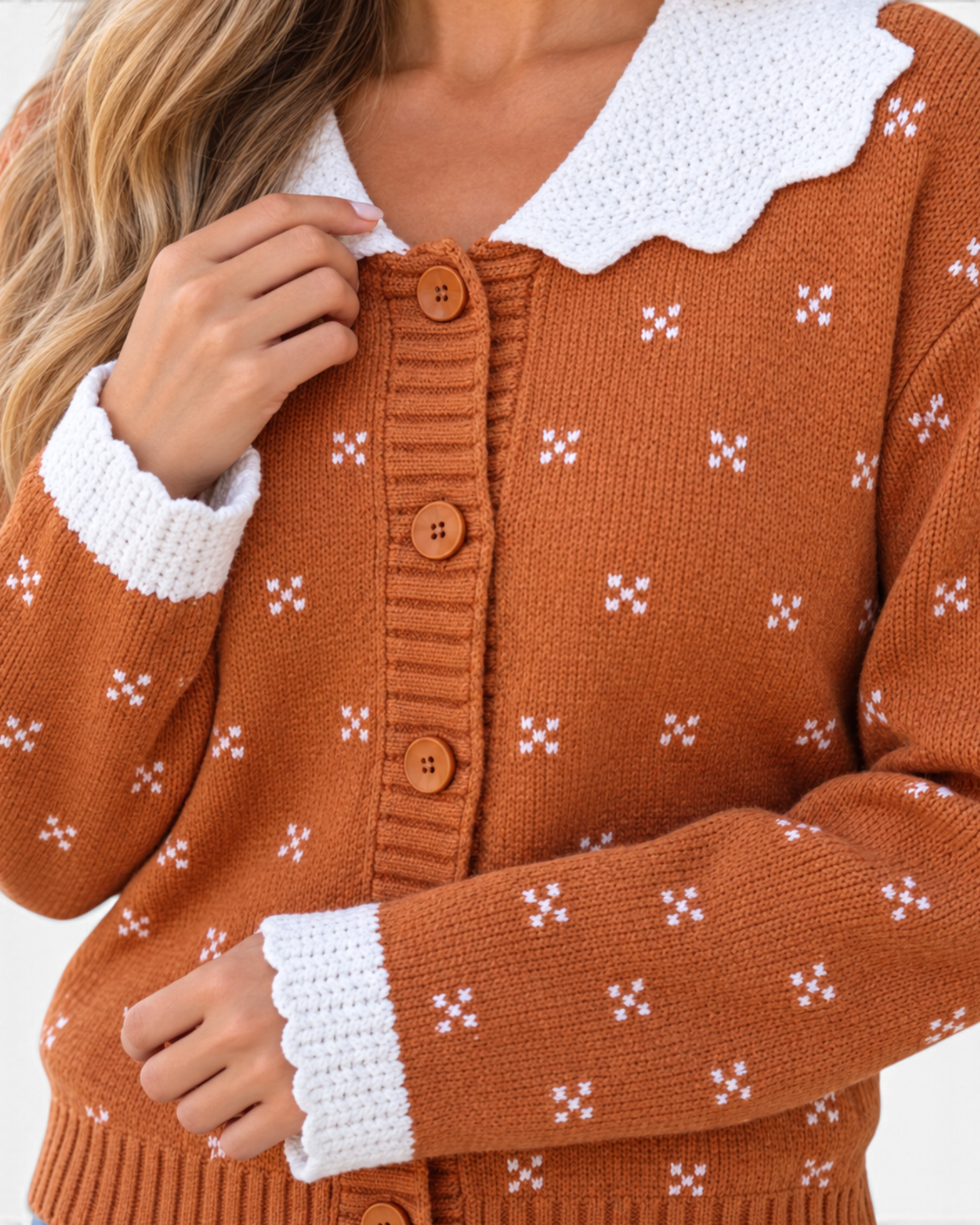 Beach Rose Co. rust cardigan with white knit motifs, a scalloped white collar, and button-front closure.
