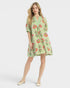 Beach Rose Co. sage green mini dress with pink, green, and coral floral print, split V-neck, and puff sleeves.