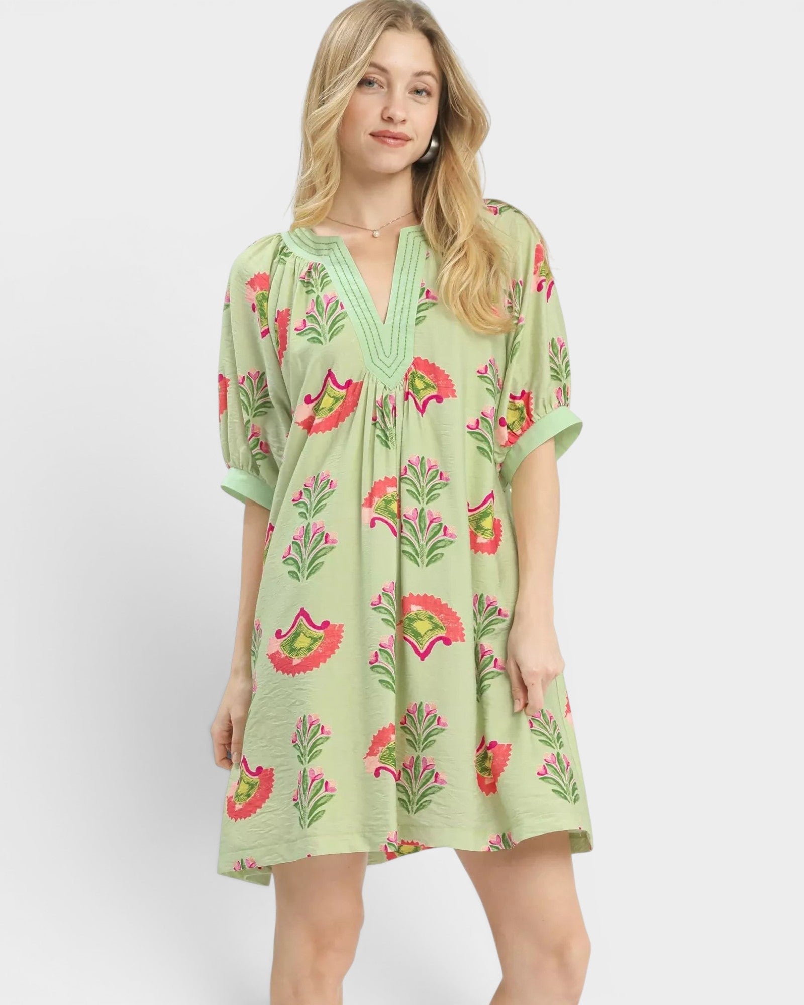 Beach Rose Co. sage mini dress with pink, green, and coral floral print, split V-neck, and puff sleeves. 85% Rayon, 15% Nylon.