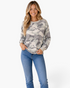 Beach Rose Co. sage and gray camo waffle knit long sleeve top with crew neck worn by a smiling blonde woman