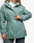 Beach Rose Co. sage green hooded jacket with drawstring waist, zip front, and snap placket over a white turtleneck.
