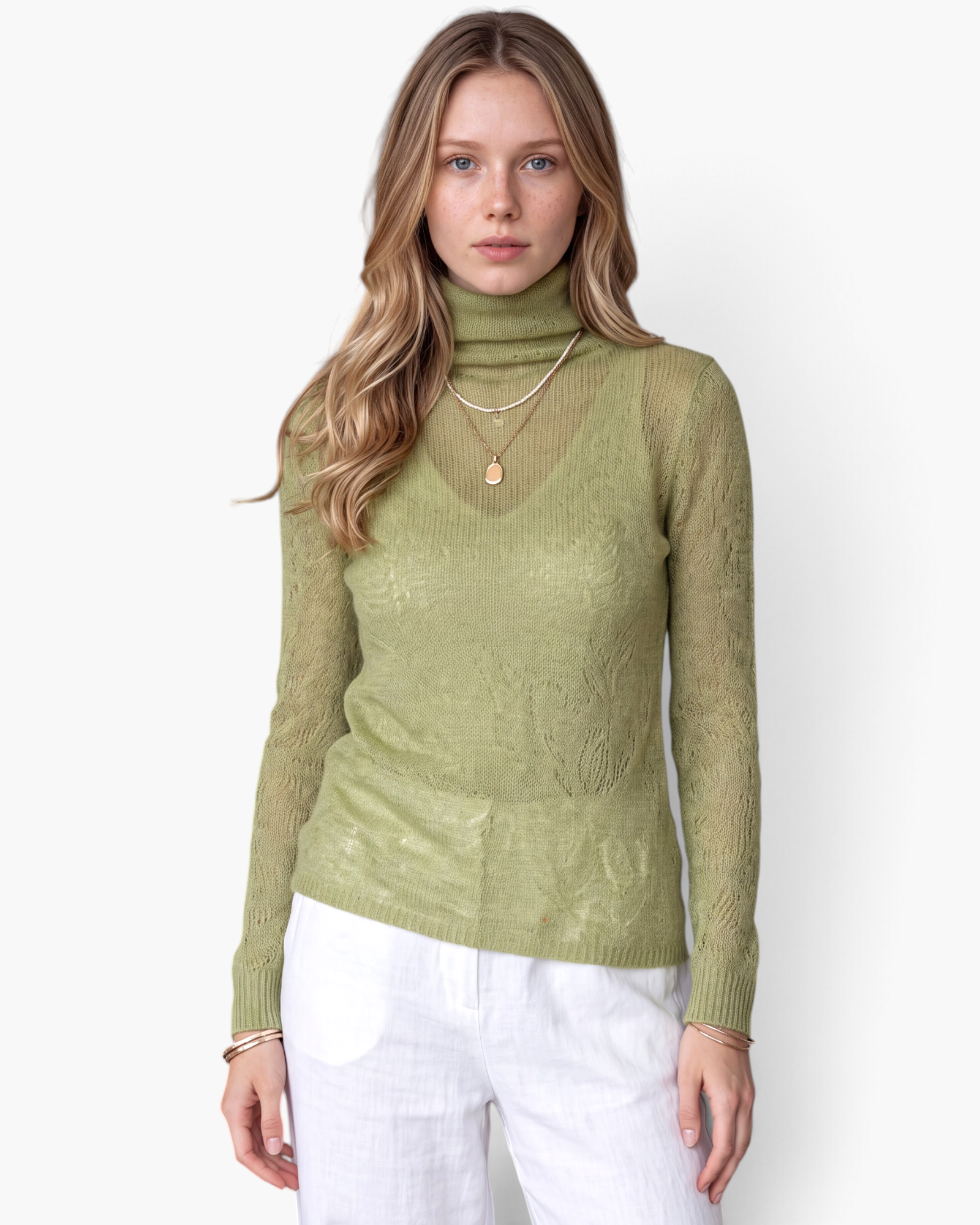 Beach Rose Co. sage green fine knit long sleeve turtleneck sweater worn by a woman with white trousers