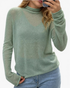 Beach Rose Co. sage green fine knit long sleeve turtleneck sweater with a sheer texture worn by a woman.