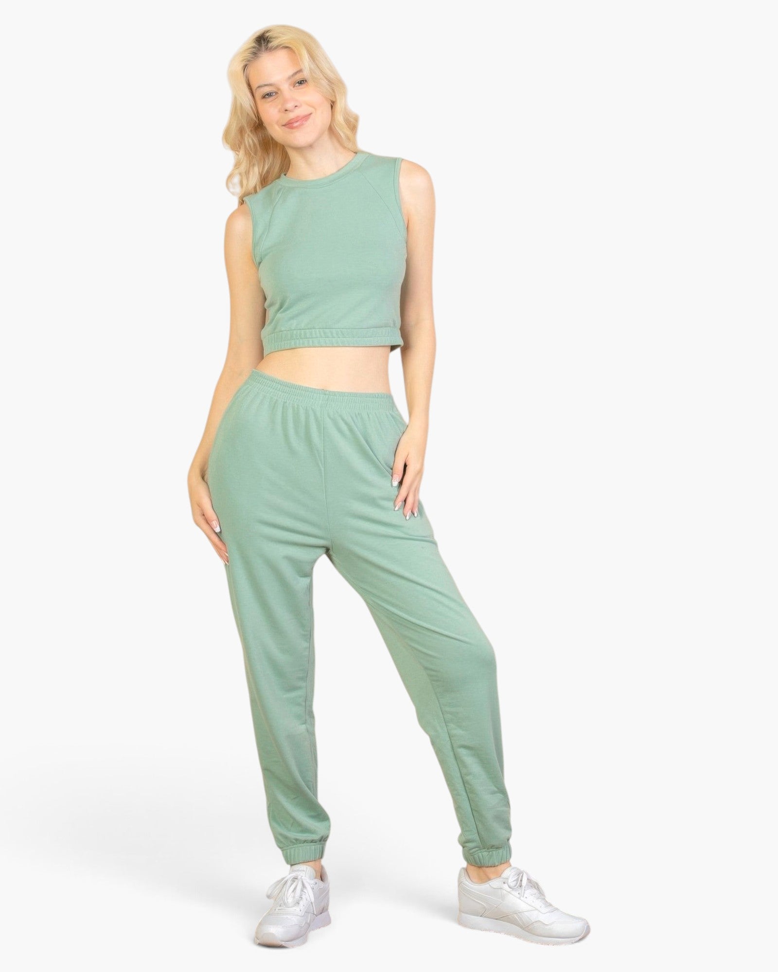 Beach Rose Co. sage green French terry tank top and joggers set worn by a blonde model with white sneakers