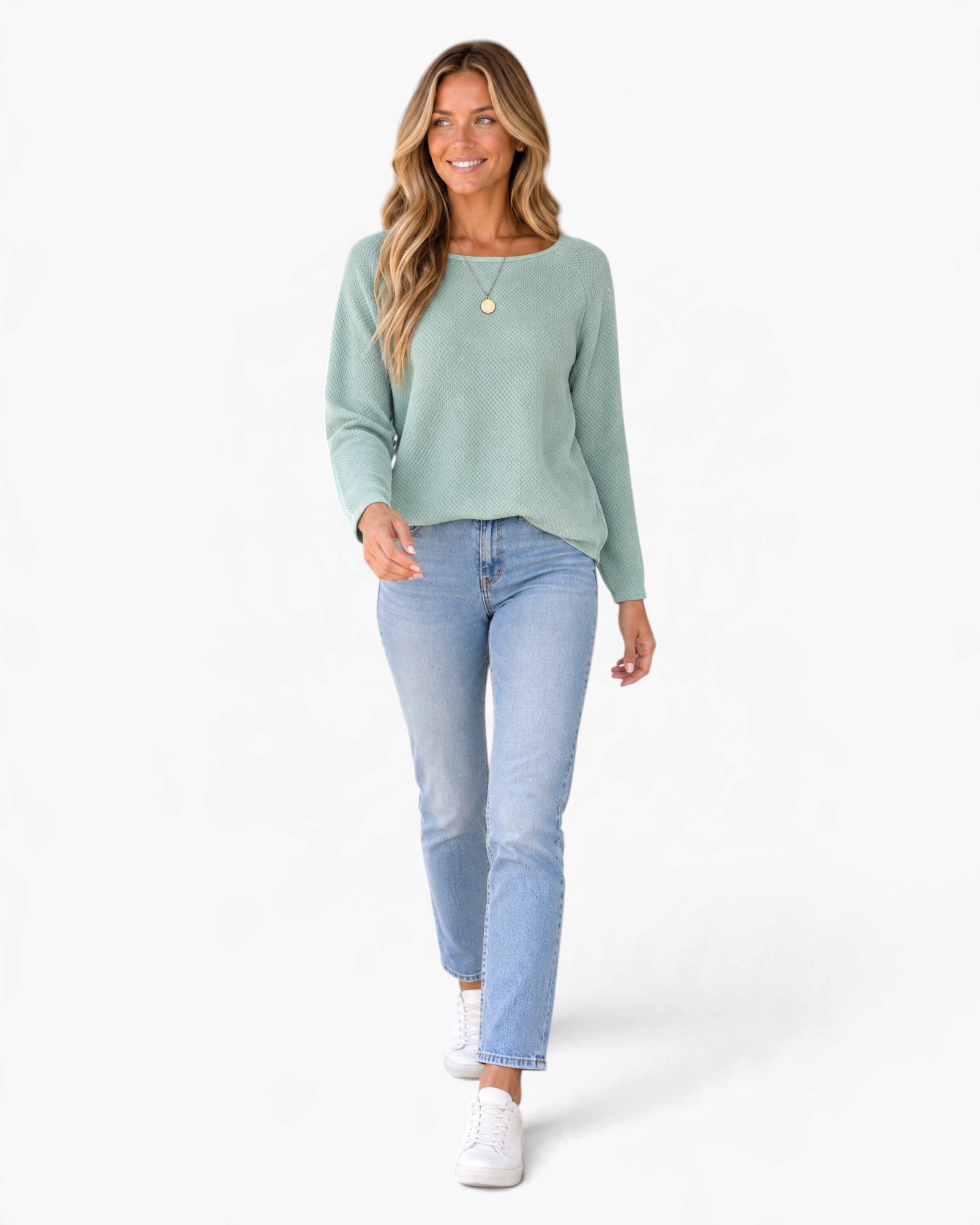 Beach Rose Co. sage green textured long sleeve raglan top worn by a smiling woman with light wash jeans and sneakers